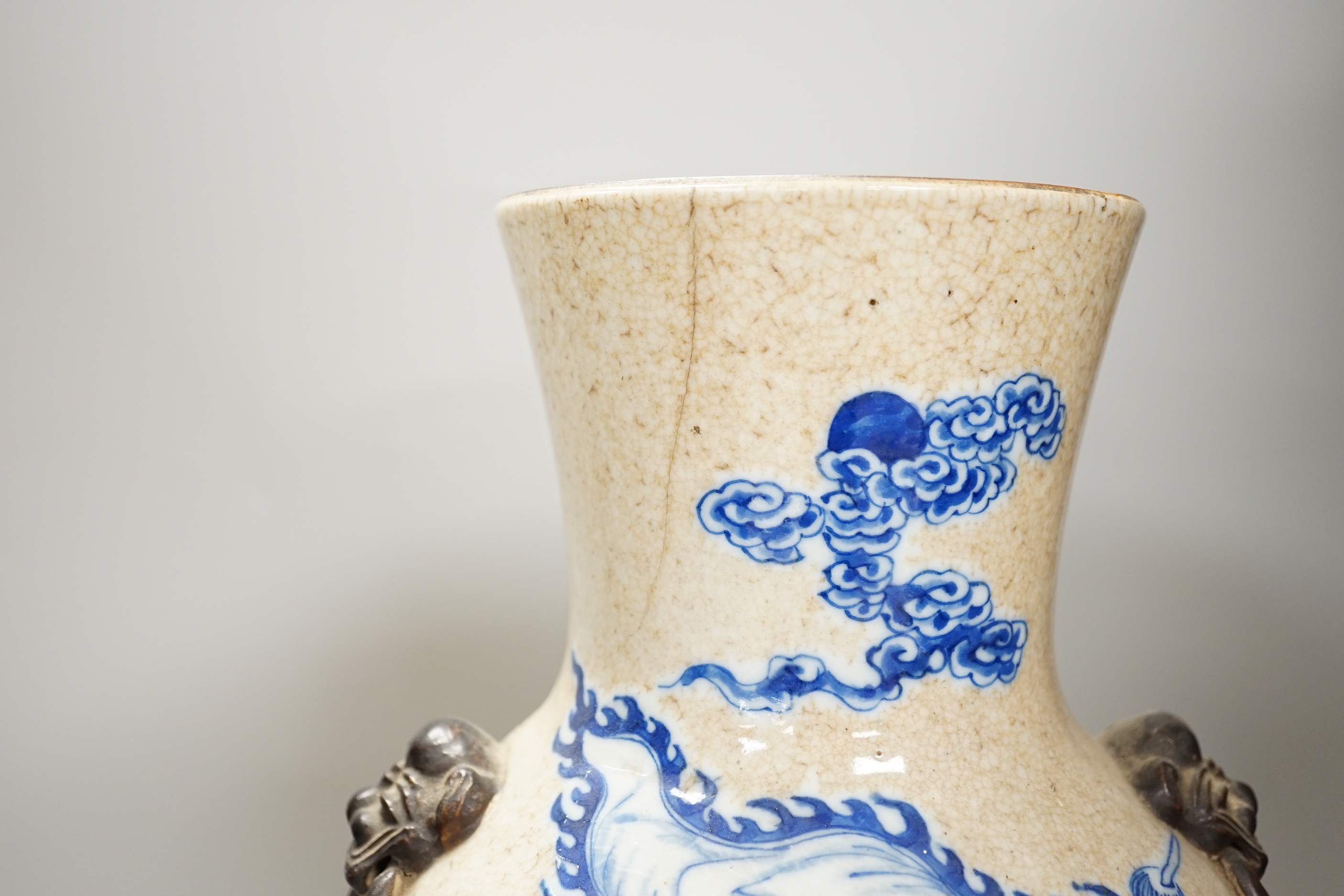 An early 20th century Chinese crackle glaze blue and white vase, 44cm and a later smaller vase